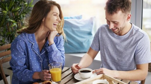 Couple having some laughs at dining table